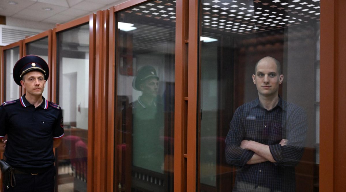 Wall Street Journal reporter Evan Gershkovich stands in the glass defendants cage in the Yekaterinburg courthouse where his trial began Wed. June 26. (Natalia Kolesnikova/AFP via Getty Images)