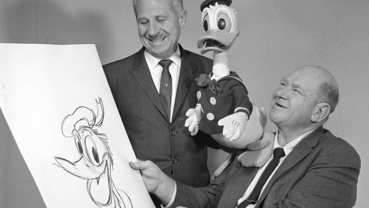 Disney artist and writer Roy Williams, right, with a drawing of Donald Duck. Donalds 25-year-old voice, Clarence \Ducky\ Nash, is pictured with a Donald Duck dummy. Both were in Springfield for the promotion of the feature film 101 Dalmatians. Nl Feb 1961 027 Disney artist and writer Roy Williams, right, with a drawing of Donald Duck. Donalds 25-year-old voice, Clarence \Ducky\ Nash, is pictured with a Donald Duck dummy. Both were in Springfield for the promotion of the feature film 101 Dalmatians.