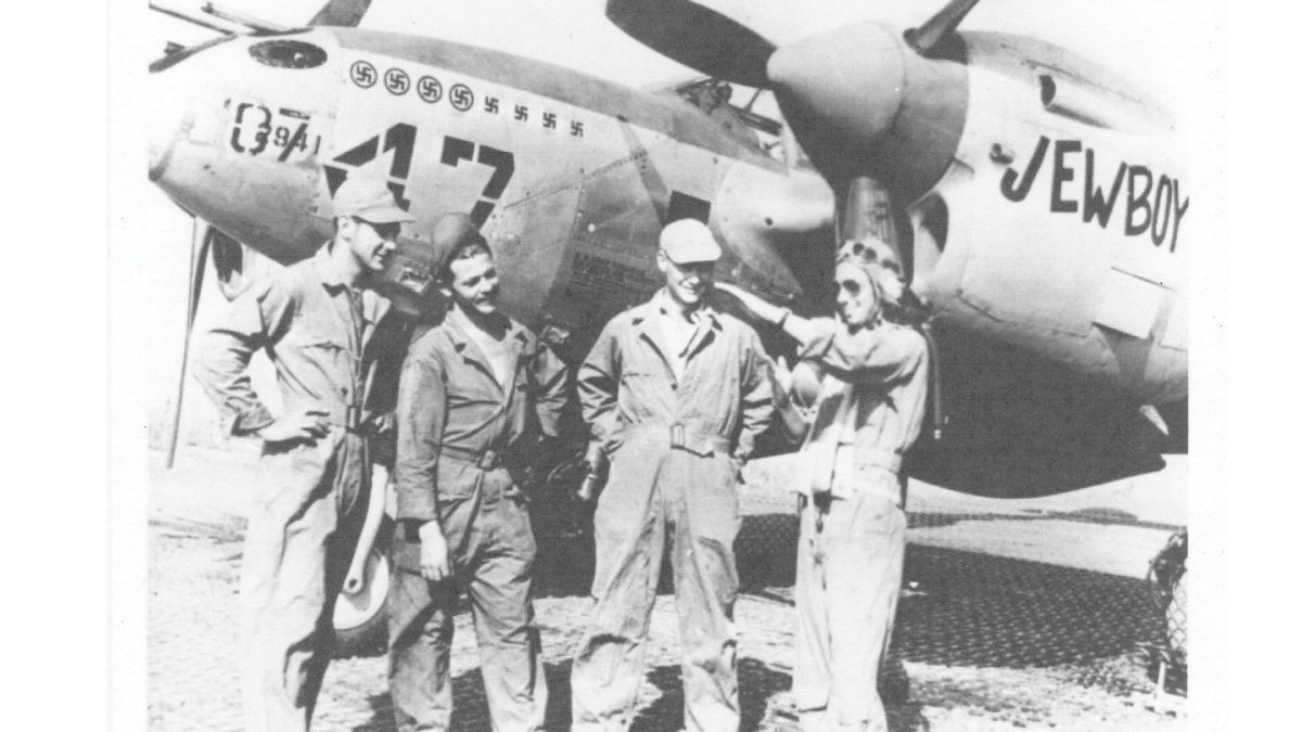 Lt. Philip Goldstein with ground crew in front of his P-38 Lightning fighter aircraft in 1944 in Triolo, Italy. 