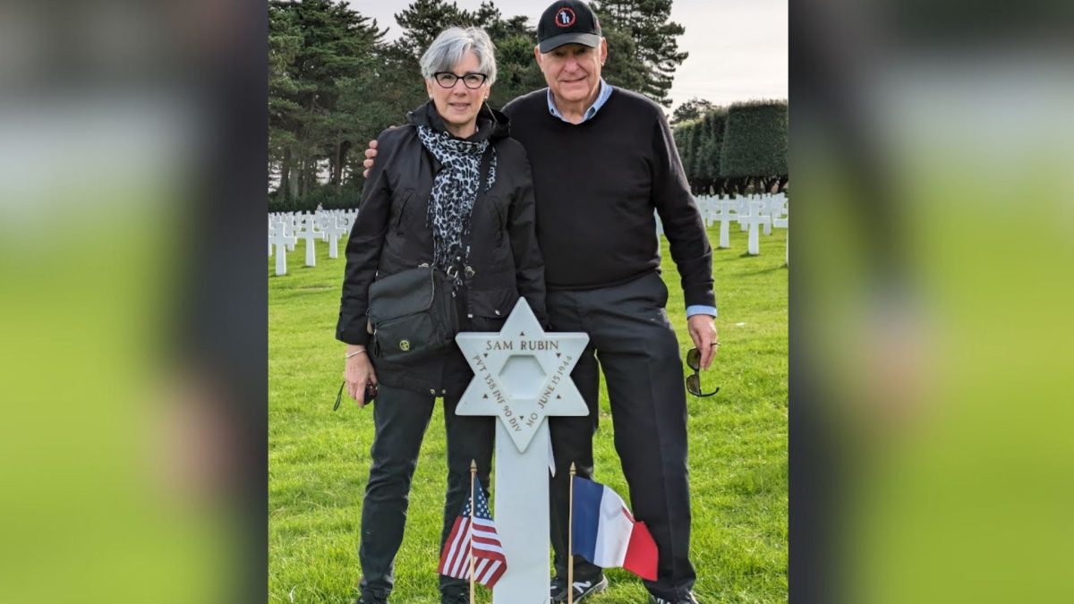Sherilyn and Barry Krell at the grave of Sam Rubin, an Army private from St. Louis who died in Normandy in 1944.