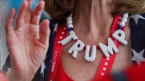 A Donald Trump supporter wears a Trump-themed necklace while waiting in line for a book signing 