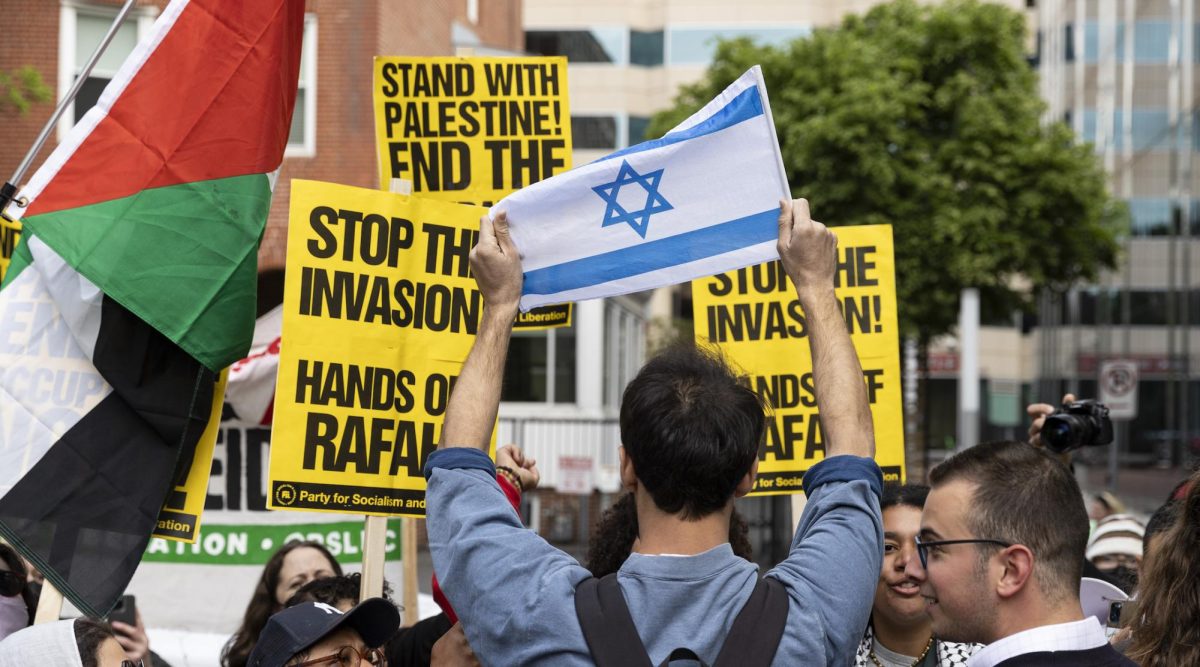 A man holds an Israeli flag while counter-demonstrating against a pro-Palestinian protest at George Washington University in Washington, D.C.,  April 25, 2024. (Mostafa Bassim/Anadolu via Getty Images)