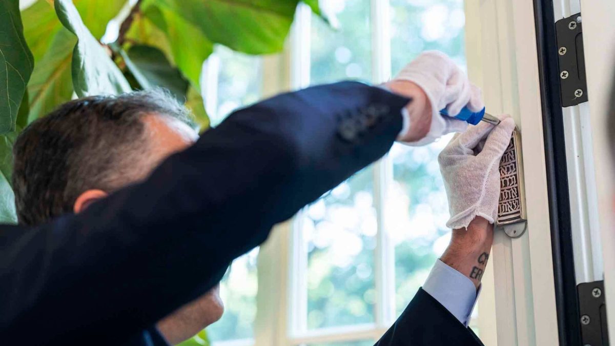 Second Gentleman Doug Emhoff affixes a mezuzah at the vice president’s residence in Washington, D.C., in 2021. Courtesy of The White House

