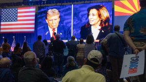 People at the Mesa Convention Center watch former President Donald J. Trump and Vice President Kamala Harris debate on Sept. 10, 2024.