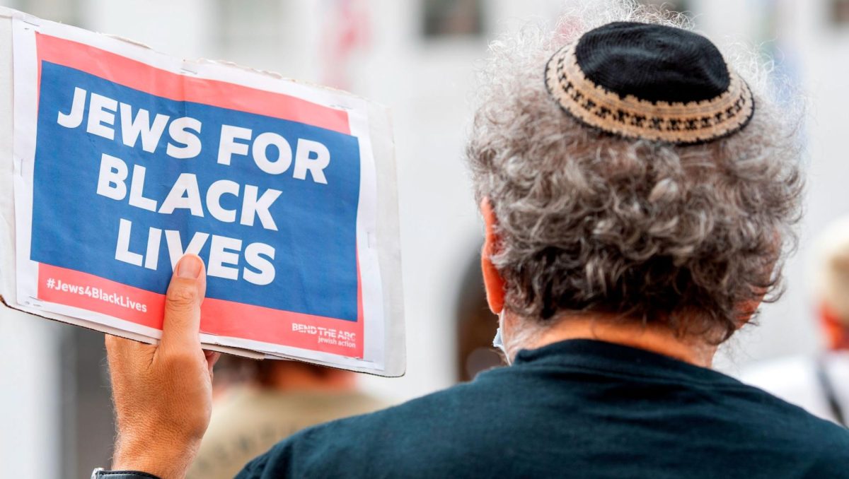 A kippah-clad man holds a sign reading "Jews for Black Lives" at the weekly Black Lives Matter "Jackie Lacey Must Go!" protest in front of the Hall of Justice in Los Angeles, Sept. 9, 2020. (Valerie Macon/AFP via Getty Images)