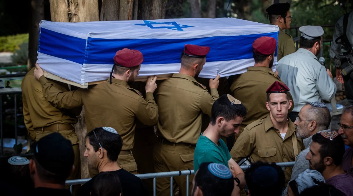 Family and friends of Israeli soldier Captain Eitan Itzhak Oster, killed during an Israeli ground operation in Southern Lebanon, attend his funeral at the Mount Herzl Military Cemetery. Jerusalem, Oct. 2, 2024. 