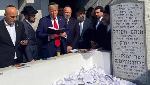 President Donald Trump, accompanied by Chabad rabbis, praying at the Rebbe's Ohel.