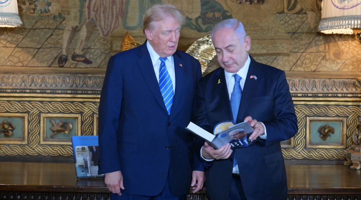 Israeli Prime Minister Benjamin Netanyahu shares with former President Donald Trump his autobiography at Trump's estate, Mar-a-Lago, Palm Beach, Florida, July 26, 2024. (Amos Ben-Gershom, Israel Government Press Office)