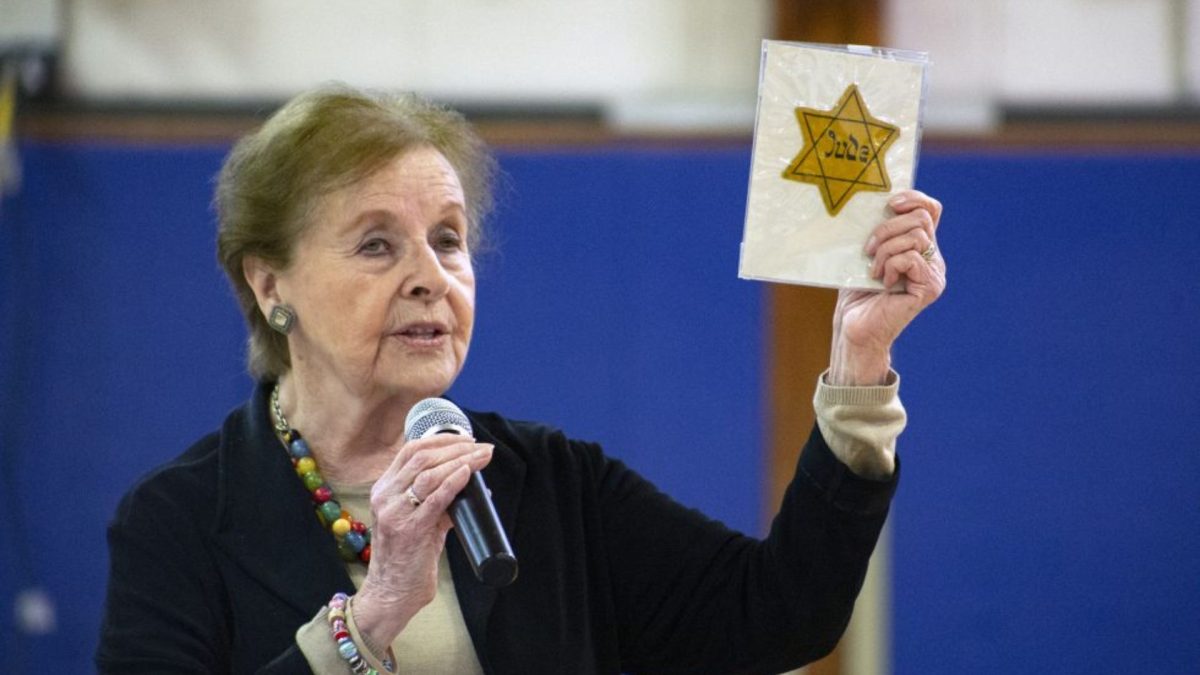 Holocaust survivor Marion Blumenthal Lazan holding a yellow star identification badge that Jewish people were forced to wear by the Nazis