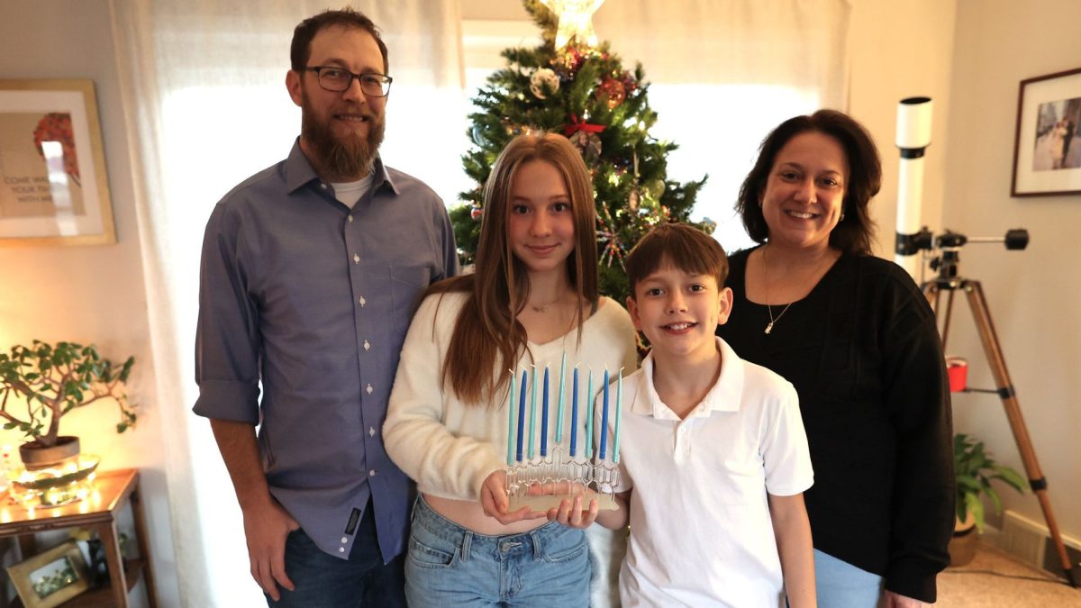 David, Mila, Emmett and Raymee Alper. The menorah Mila is holding was designed and created by David, who is a glass artist.
