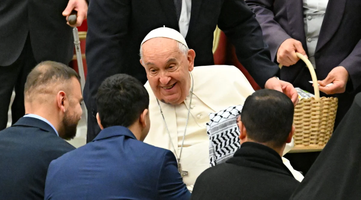 Members of the Palestinian embassy to the Holy See give a keffiyeh, a traditional Palestinian scarf, to Pope Francis during a Christmas ceremony at St Peter's Square at the Vatican, Dec. 7, 2024. (Andreas Solaro/AFP via Getty Images)