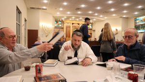 Above, from left, Harvey Iken, Rabbi Daniel Sentell and Bruce Waxman take part in a Partners in Torah session at Nusach Hari B’nai Zion in November.  Photo: Bill Motchan