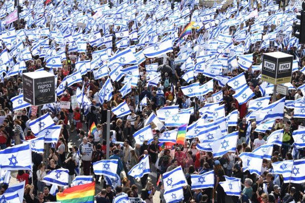 Thousands of Israeli protesters wave flags during a rally against the Israeli government's judicial overhaul bills in Jerusalem, March 27, 2023. 