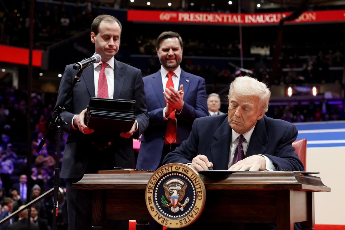 U.S. President Donald Trump signs executive orders on the first day of his second term, as Vice President JD Vance (center) looks on, Jan. 20, 2025. Credit: White House.