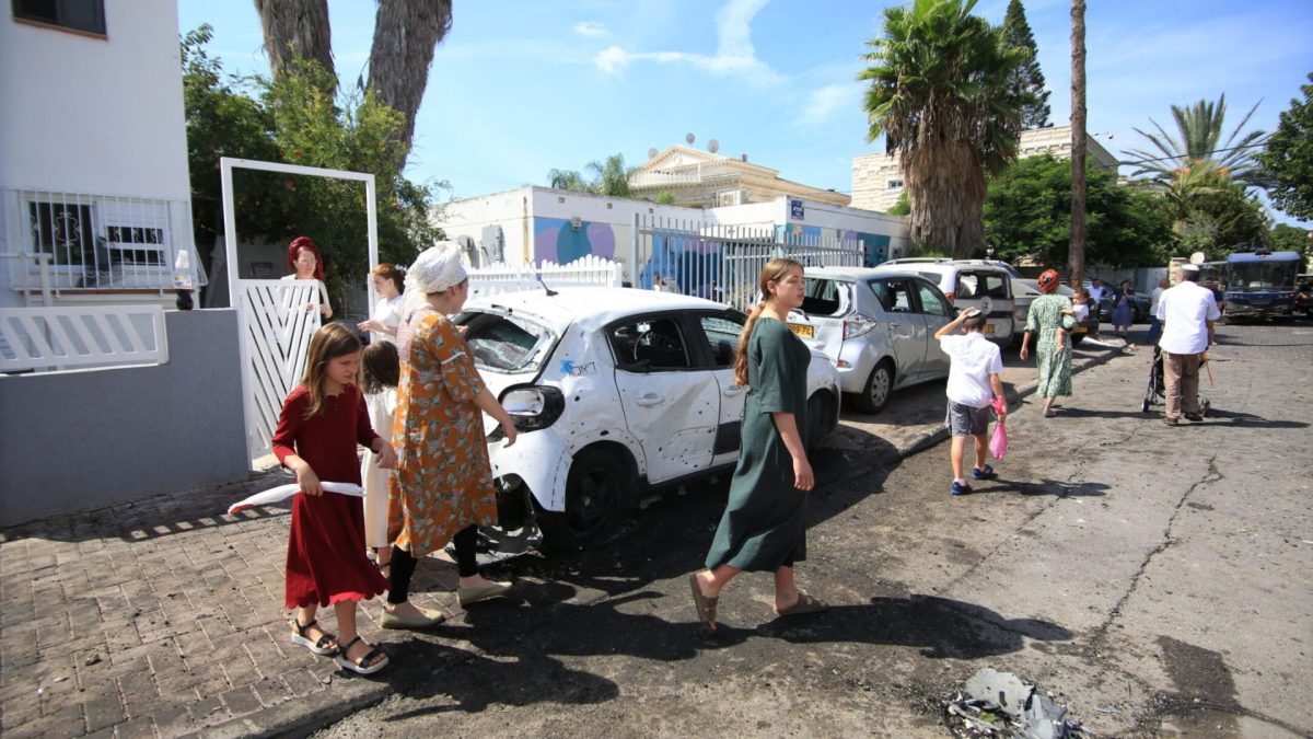 Israelis leave their damaged houses after Hamas rocket strikes in Ramla, Israel, near Tel Aviv, Oct. 7, 2023. 