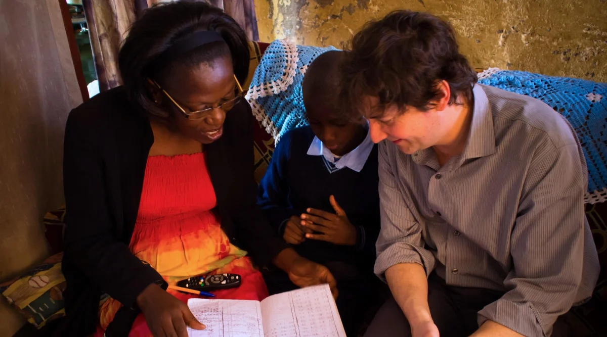 Sasha Chanoff, right, founder and CEO of RefugePoint, reviews a case with a staff worker and a refugee client in Kenya enrolled in the organization’s Nairobi-based Urban Refugee Protection Program. (Courtesy of RefugePoint)