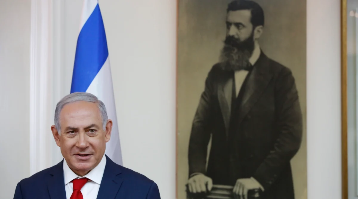 Israeli Prime Minister Benjamin Netanyahu is seen before a portrait of Theodor Herzl, known as the "Visionary of the Jewish State" and the founder of modern Zionism in Jerusalem on May 2, 2018. 