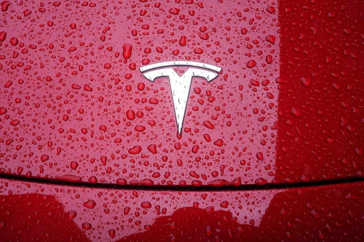 A Tesla logo is pictured on a car in the rain in the Manhattan borough of New York City, New York, U.S., May 5, 2021. REUTERS/Carlo Allegri