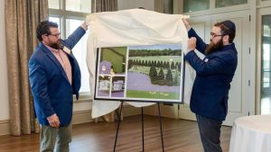 Rabbi Chaim Landa, co-director of the Chabad-Lubavitch Jewish Center of St. Charles County, and Colby Hitchcock, director of operations at Baue Funeral Homes, unveil plans for the new Jewish cemetery in St. Charles, Missouri.
