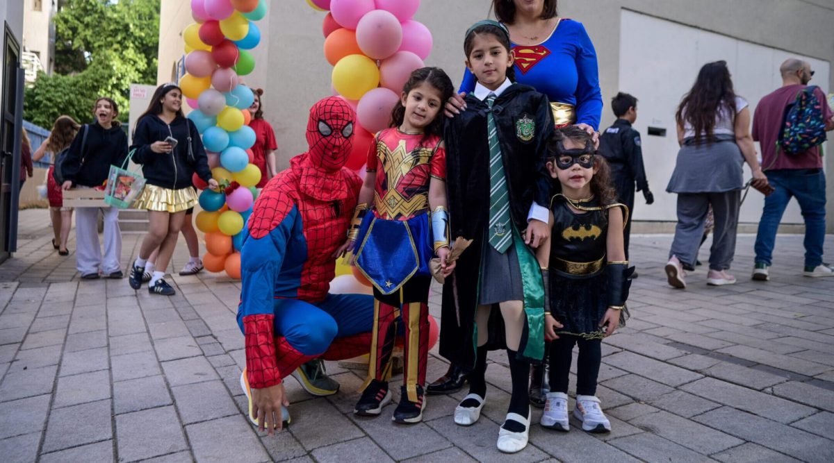 Children and their teachers and parents dressed up for Purim, some as Batman in honor of the slain Bibas brothers, at the Gabrieli Carmel School in Tel Aviv, March 13, 2025.(Avshalom Sassoni/Flash90)