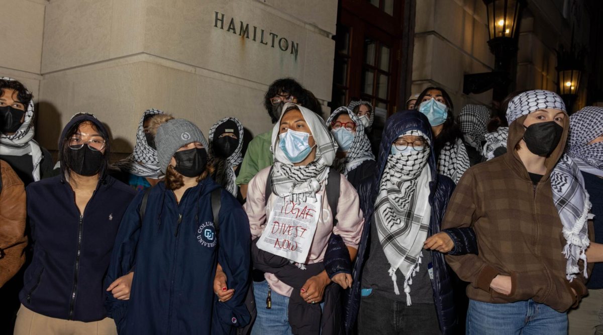 Students/demonstrators lock arms to guard potential authorities against reaching fellow pro-Palestinian protesters who barricaded themselves inside Columbia University's Hamilton Hall, April 29, 2024. (Alex Kent/Getty Images)
