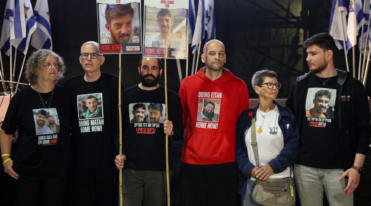 Freed Israeli hostages Aviva Siegel, Keith Siegel, Yarden Bibas, Yair Horn, Yocheved Lifshitz and Sasha Trufanov hold a protest calling for the end of the war and the release of the remaining Israeli hostages held captive in Gaza in Tel Aviv's Hostages Square, March 18, 2025.
