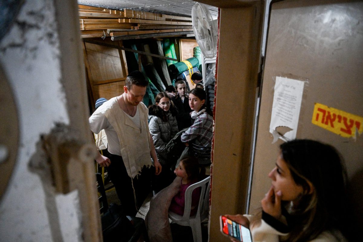 People take cover in a stairway in Jerusalem, as a red alert is sounded when drones and missiles fired from Iran neared Israel, April 14, 2024. (Photo: Arie Leib Abrams/Flash90)