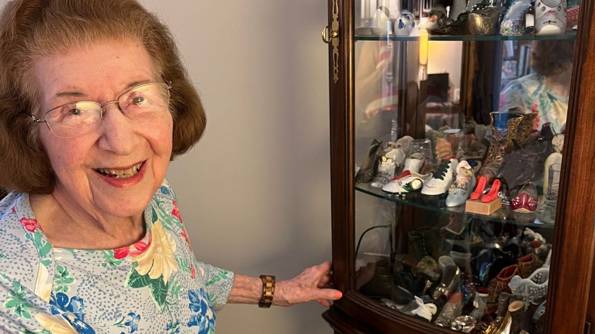 Shirley Mosinger shows off pieces from her collection of miniature shoes, including high heel erasers (top right), salt-and-pepper-shaker boots (center), a shoe oil lamp (above right) and a 1904 World’s Fair souvenir. 