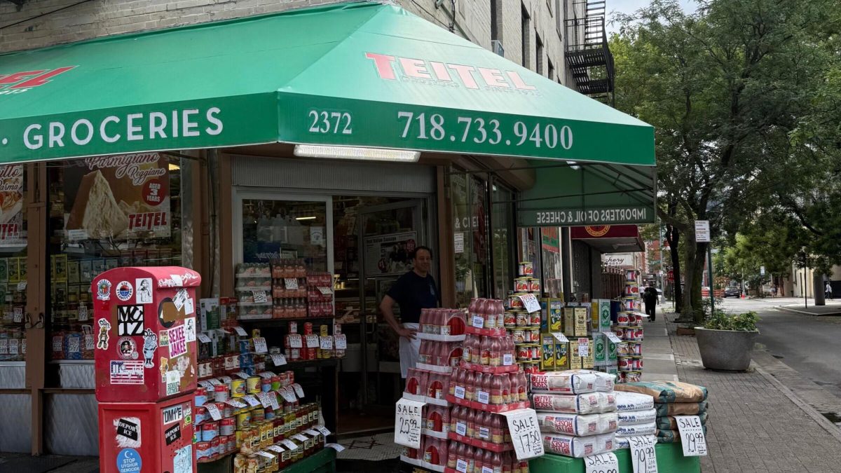 Teitel Brothers Wholesale Grocery on Arthur Avenue and 186th Street. Eddie Teitel stands by the entrance. Photo by PJ Grisar