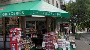 Teitel Brothers Wholesale Grocery on Arthur Avenue and 186th Street. Eddie Teitel stands by the entrance. Photo by PJ Grisar