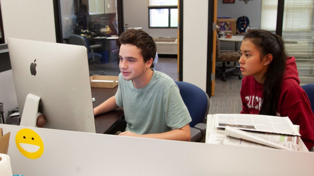 In a 2018 photo, then-co-editor Adam Rush and writer Olivia Riutcel work on an Ohr Chadash section in the Jewish Light office. File Photo: Mike Sherwin
