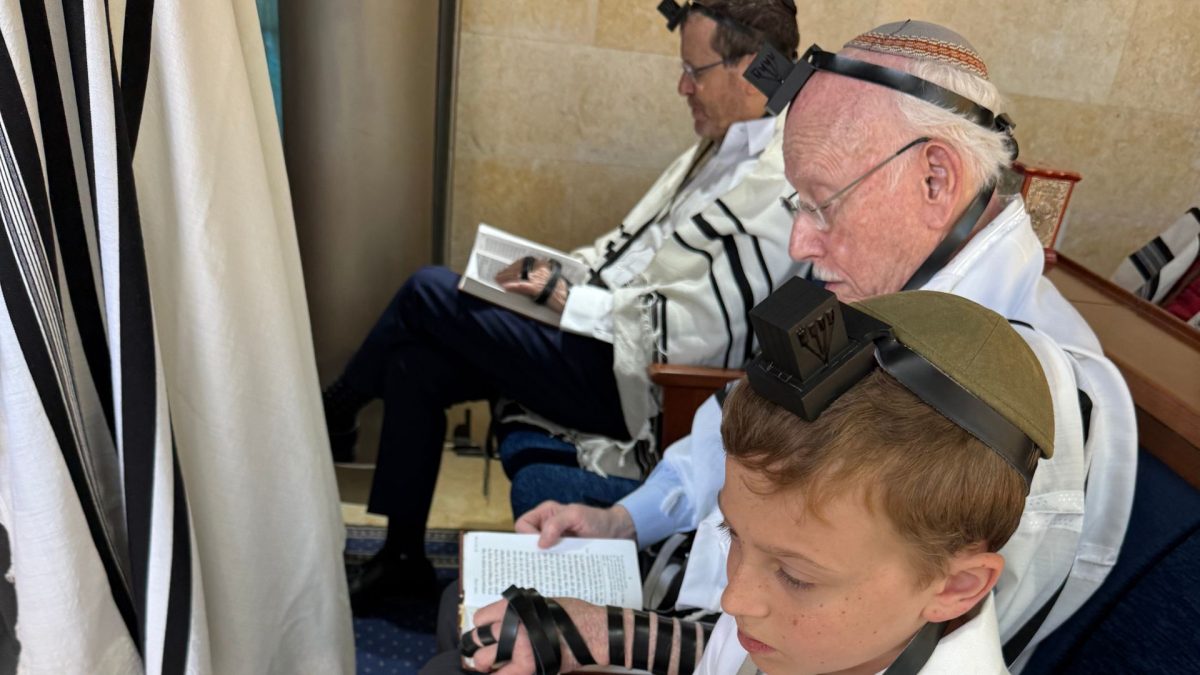 Heschel Raskas (center) and his grandson, Aaron Raskas, take part in morning minyan with Israeli President Isaac Herzog last month in Israel, a few days before Aaron’s bar mitzvah.