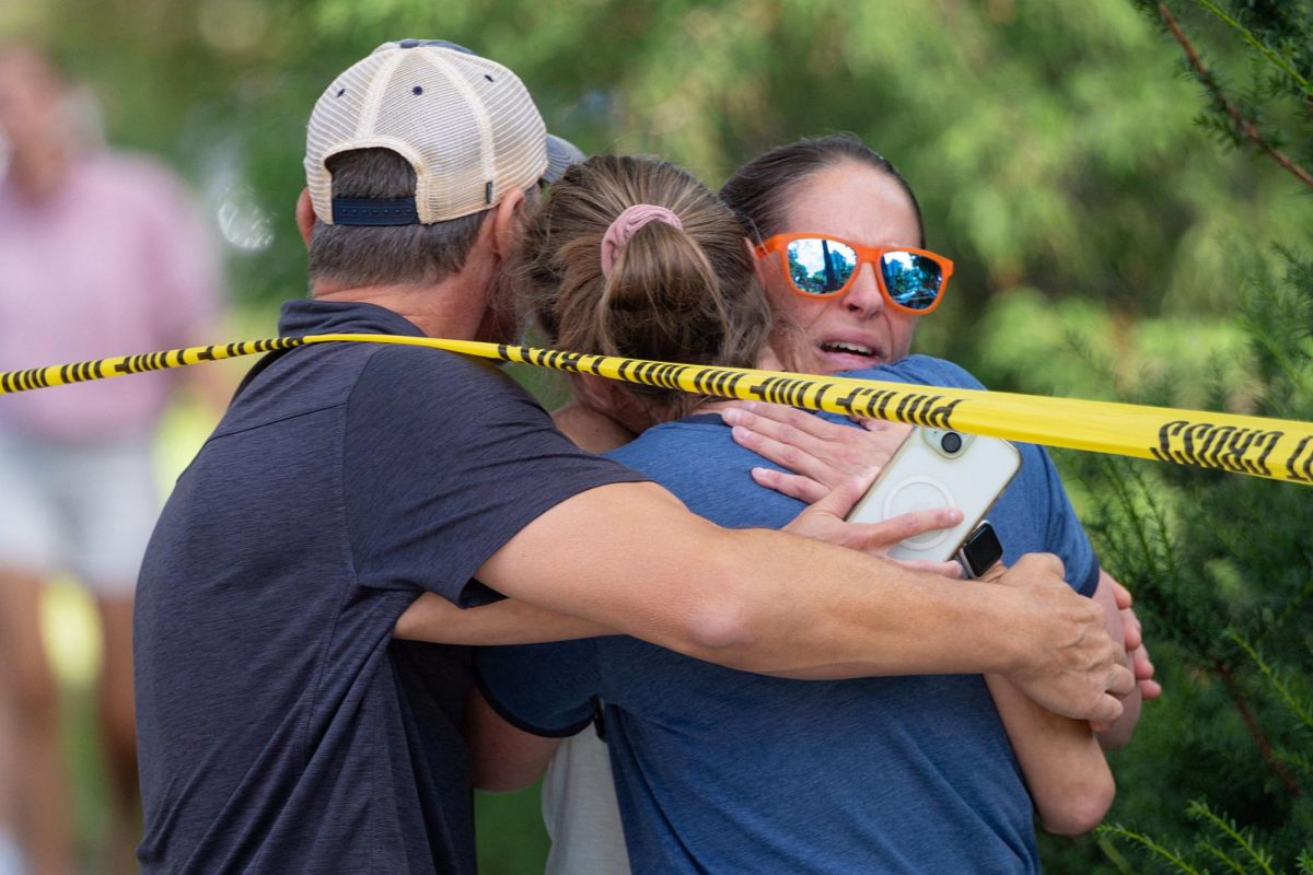 Families and loved ones reunite outside the police barricades after a shooting at Annunciation Church, which is also home to a an elementary school, in Minneapolis, Minnesota, U.S. August 27, 2025.  REUTERS/Ben Brewer