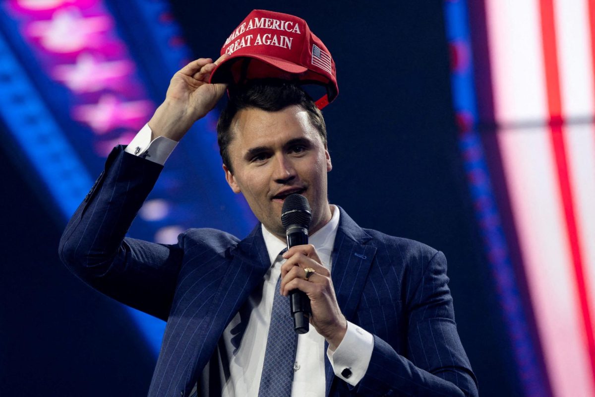 Charlie Kirk, Turning Point USA founder, puts on a MAGA hat during the AmericaFest 2024 conference sponsored by conservative group Turning Point in Phoenix, Arizona, U.S. December 19, 2024.  REUTERS/Cheney Orr