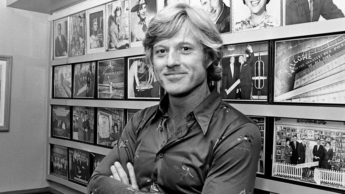 Actor Robert Redford relaxes in the Belle Meade Theater manager's office for the conclusion of the Nashville premiere of his "All the President's Men" movie June 10, 1976. 760610 H