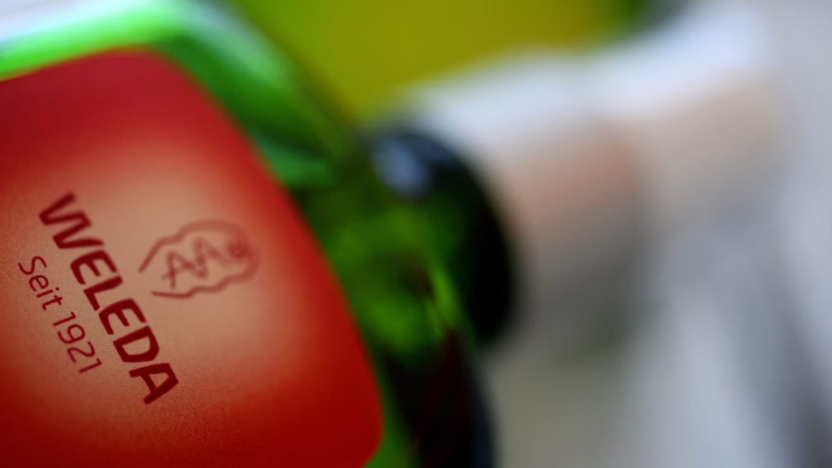 The company logo of Weleda is on a glass bottle. Weleda produces herbal medicines and cosmetics. (Stefan Puchner/picture alliance via Getty Images)