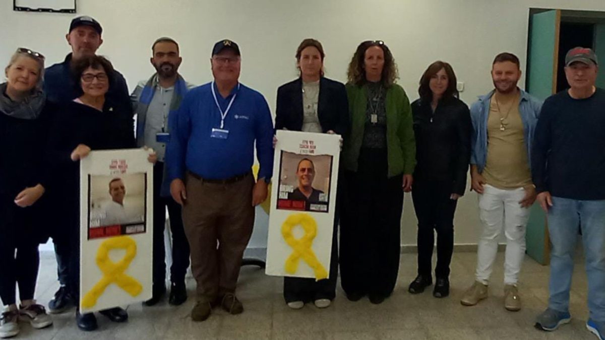 The Jewish Federation of St. Louis’ Israel and Overseas Committee at Nachal Oz with photos of the two hostages taken from Nachal Oz. Both are back safe with their families.