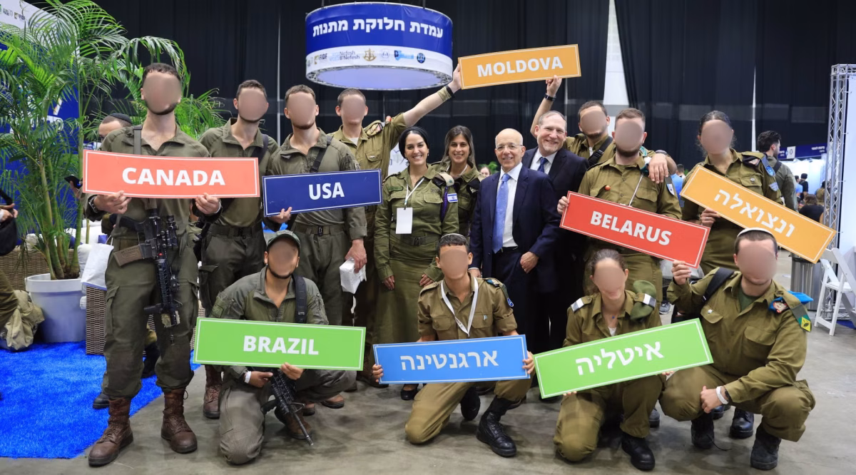 Over 4,000 Israeli Lone Soldiers hailing from 70 countries attended a unique Errands Day event in Tel Aviv organized in part by Nefesh B'Nefesh, the immigration-assistance organization co-founded by Tony Gelbart, left center, and Rabbi Yehoshua Fass, right center. The soldiers' faces are blurred to protect their identities. (Yonit Schiller)