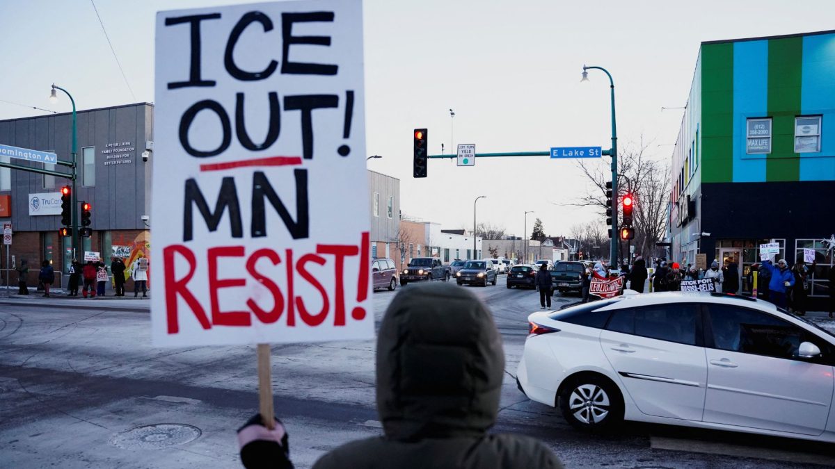 A person holds up a sign during a demonstration against the presence of federal immigration agents in Minneapolis, Minnesota, U.S., January 28, 2026. REUTERS/Seth Herald