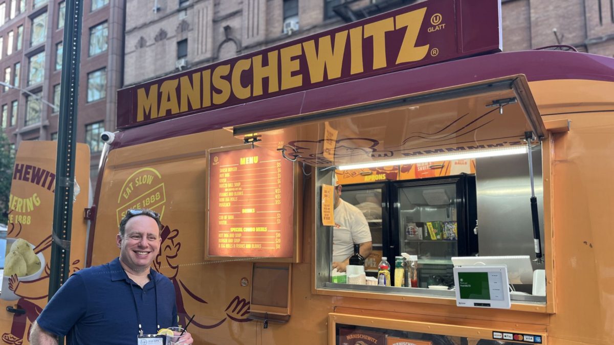 ABOVE:  Lonny Goldsmith, editor-in-chief of TC Jewfolk in Minneapolis, ‘hams’ it up in front of the Manischewitz Food Truck.   