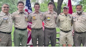 Aidan, Caleb and Noah Kornblum, pictured with leaders of Troop 11 at a ceremony in Faust Park in June.